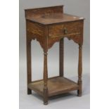 A late Victorian oak side table, fitted with a single drawer, raised on turned and block legs united