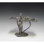 An Art Nouveau WMF plated centrepiece stand, modelled as a fairy holding a bird, supporting a lily