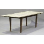 A 20th century stripped pine kitchen table, the rectangular top raised on tapering block legs,