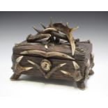 An early 20th century carved oak and antler mounted box, possibly Black Forest, width 30cm.Buyer’s