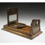 A Victorian walnut table top stereoscopic viewer, raised on a flared rectangular base, length