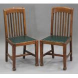 A set of six early 20th century Arts and Crafts style oak rail back dining chairs with green