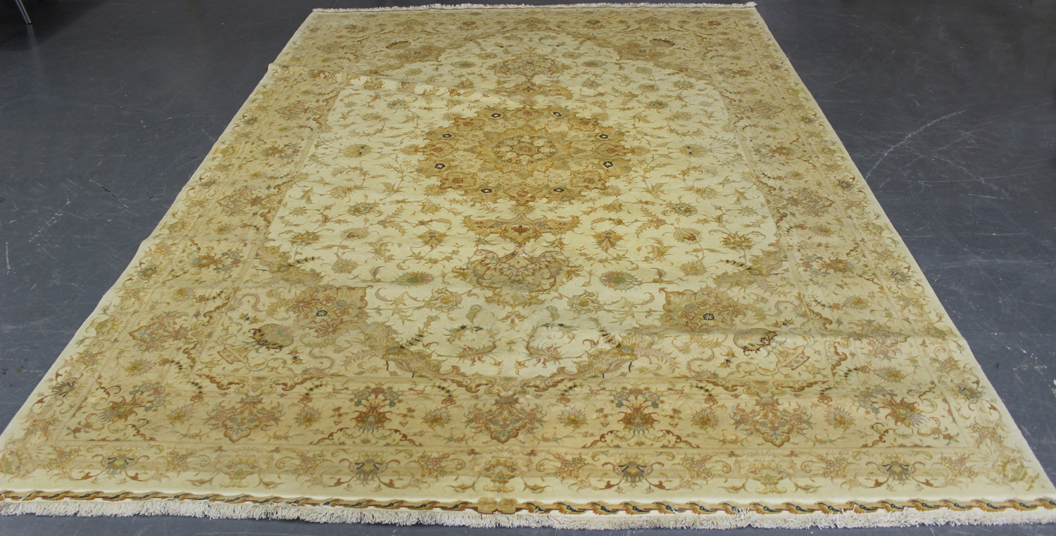 A fine Tabriz carpet, Central Persia, modern, the ivory field with a flowerhead medallion, supported