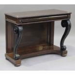 A Regency rosewood and ebonized console table, the gadrooned edge above a drawer, raised on scroll