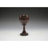A 19th century coconut bowled goblet, the turned beech stem on a stepped mahogany circular foot,