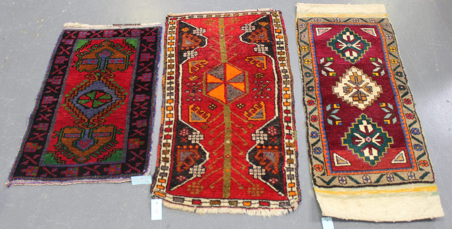 A small Turkish rug, late 20th century, the red field with a pole medallion, within an ivory border,