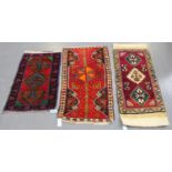 A small Turkish rug, late 20th century, the red field with a pole medallion, within an ivory border,