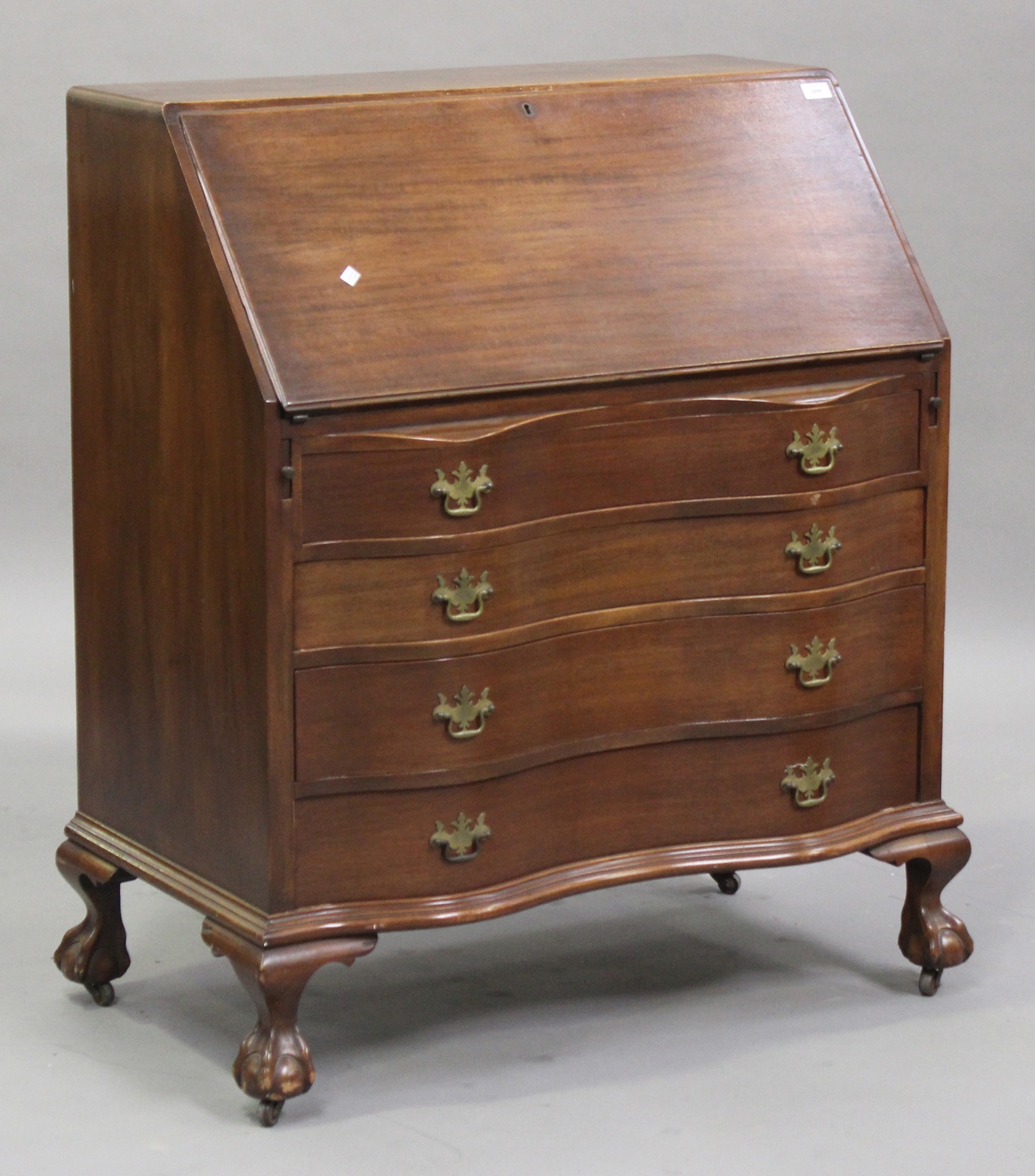 A 20th century mahogany bureau, the fall front above four long drawers, on cabriole legs and claw