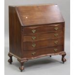 A 20th century mahogany bureau, the fall front above four long drawers, on cabriole legs and claw
