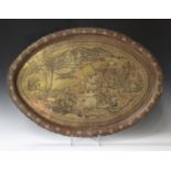 An early/mid-20th century Indian brass oval tray, engraved and coloured with a hunting scene, length