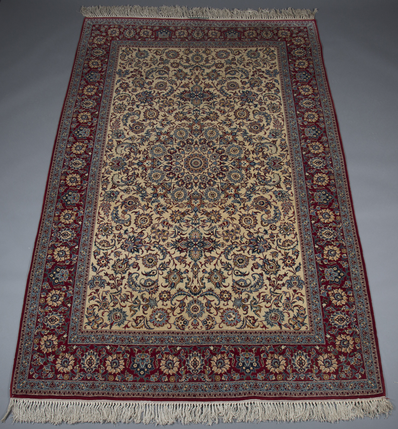 An Esfahan rug, Central Persia, mid-20th century, the ivory field with a palmette and flowerhead