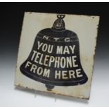 An N.T.C. 'You May Telephone From Here' double-sided enamelled road sign, designed with a large blue