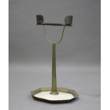 A late 19th century brass parrot perch, the turned hardwood rail flanked by a pair of tin feeders,