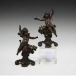 A pair of late 19th century brown patinated cast bronze figural vase holders, one modelled as a