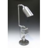 A modern industrial style table lamp, formed from various metalware and piping, height 74cm.Buyer’