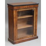 A late Victorian walnut and inlaid pier cabinet, fitted with a single glazed panel door, on a plinth