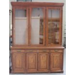 A late Victorian figured mahogany library bookcase cabinet by Harrison & Son, Burnley, the moulded