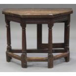 A Victorian oak credence table, the octagonal fold-over top raised on turned and block legs united