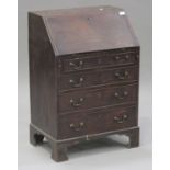 A 19th century mahogany bureau of small proportions, the fall flap above four drawers, on bracket
