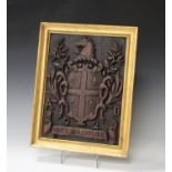 A 20th century carved mahogany heraldic crest, inscribed 'Martis Non Cupidinis', 40cm x 30cm, within