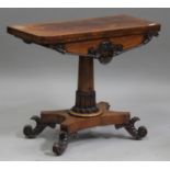 A William IV rosewood fold-over card table with carved scroll decoration, the quatrefoil platform