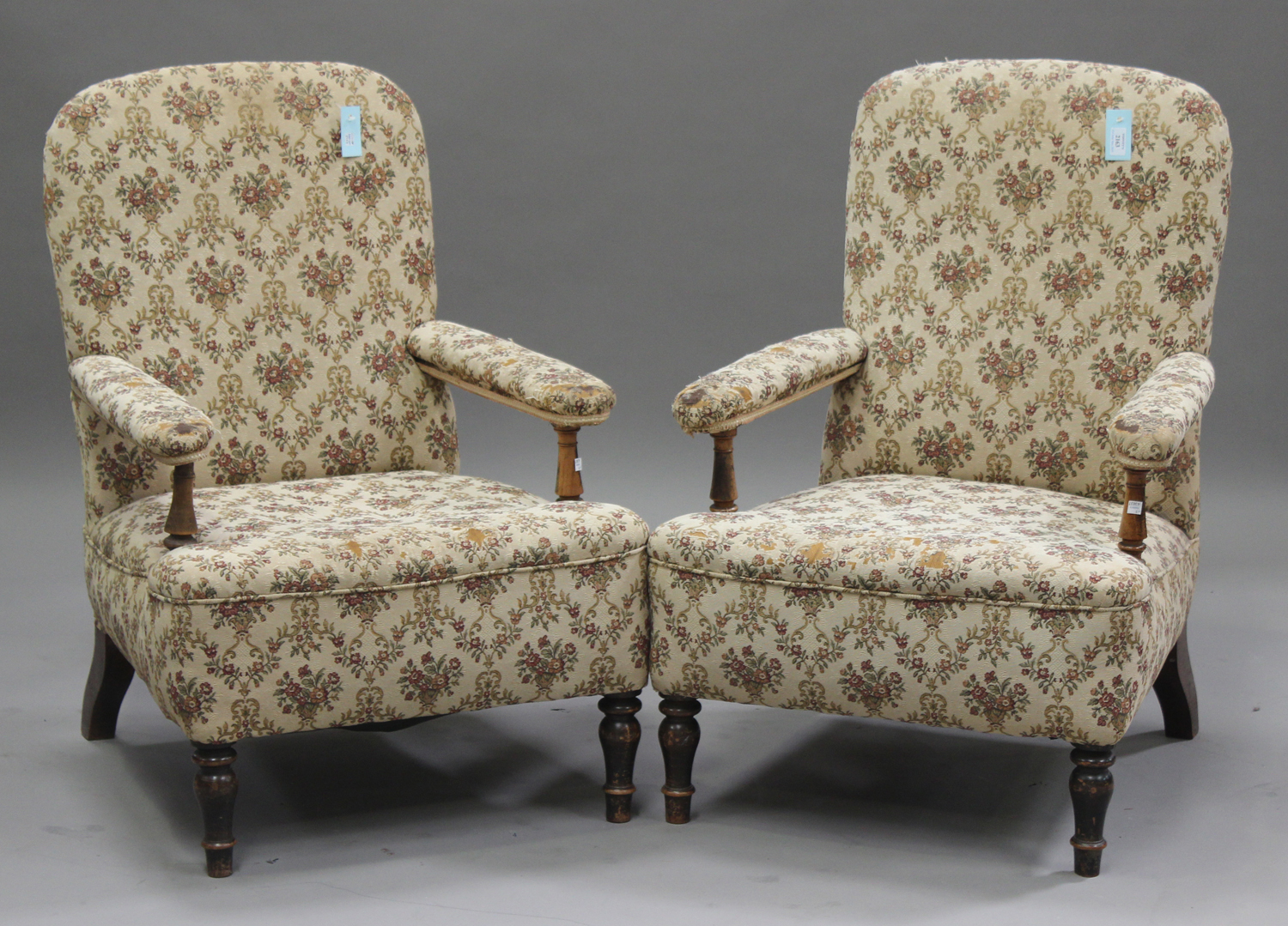 A pair of late 19th/early 20th Century beech and walnut open armchairs, upholstered in a machined