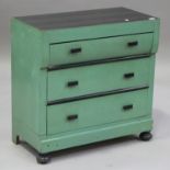 An early 20th century Scandinavian black and green painted pine chest of three drawers, on bun feet,