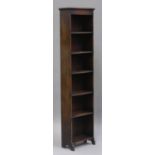 An early 20th century oak narrow bookcase, fitted with six shelves, on shaped side supports,