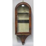 An unusual Victorian figured mahogany hanging glazed wall cabinet, the domed top above an arched