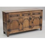 A 20th century Carolean Revival oak dresser base, fitted with three drawers above panelled