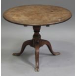A George III mahogany tip-top circular wine table, on a turned column and tripod cabriole legs,