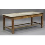 A late 19th century pine kitchen table, the rectangular top raised on block legs united by