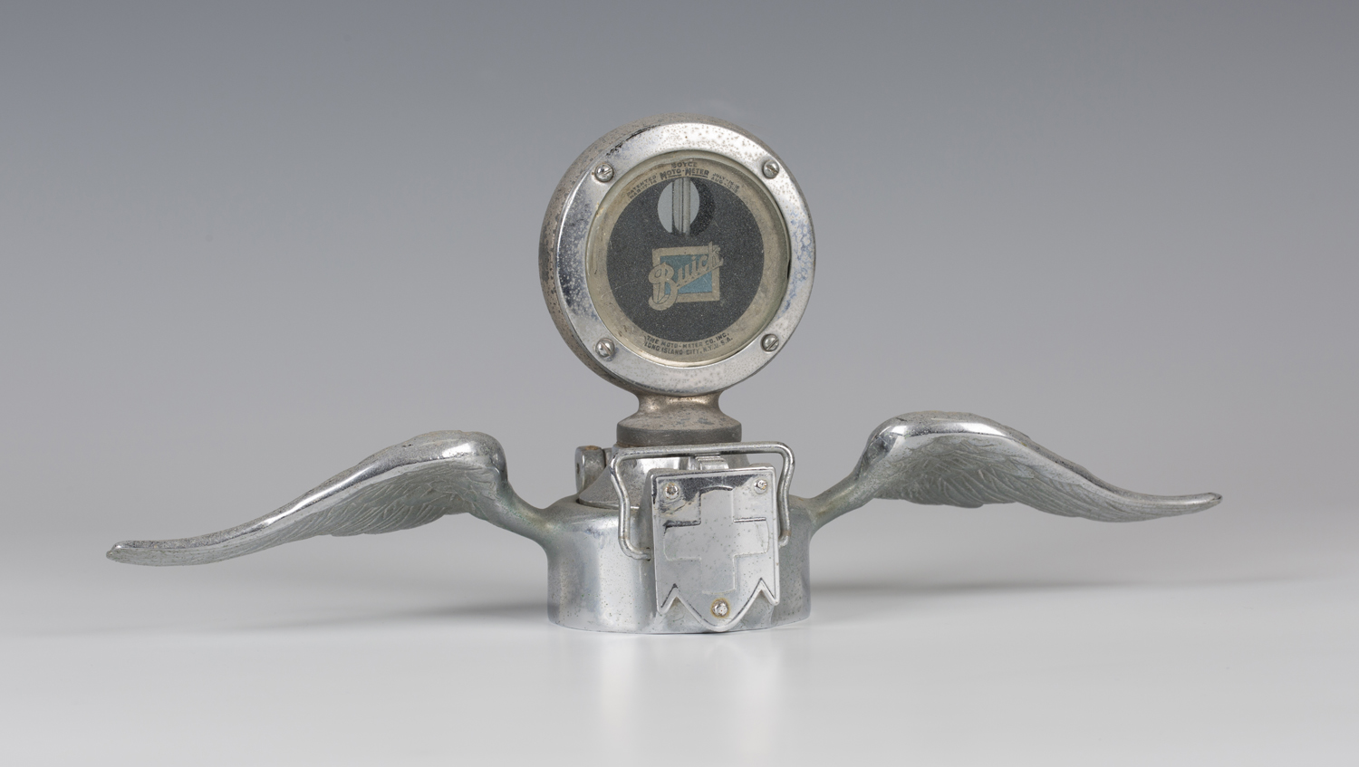 A Boyce Moto-Meter for a Buick motor car, with chromium plated finish and quick release cap, flanked