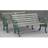 A pair of Victorian style cast iron garden benches with slatted seats and backs, the arms cast