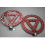 Two mid-20th century cast alloy circular warning road signs, both inset with red reflectors,
