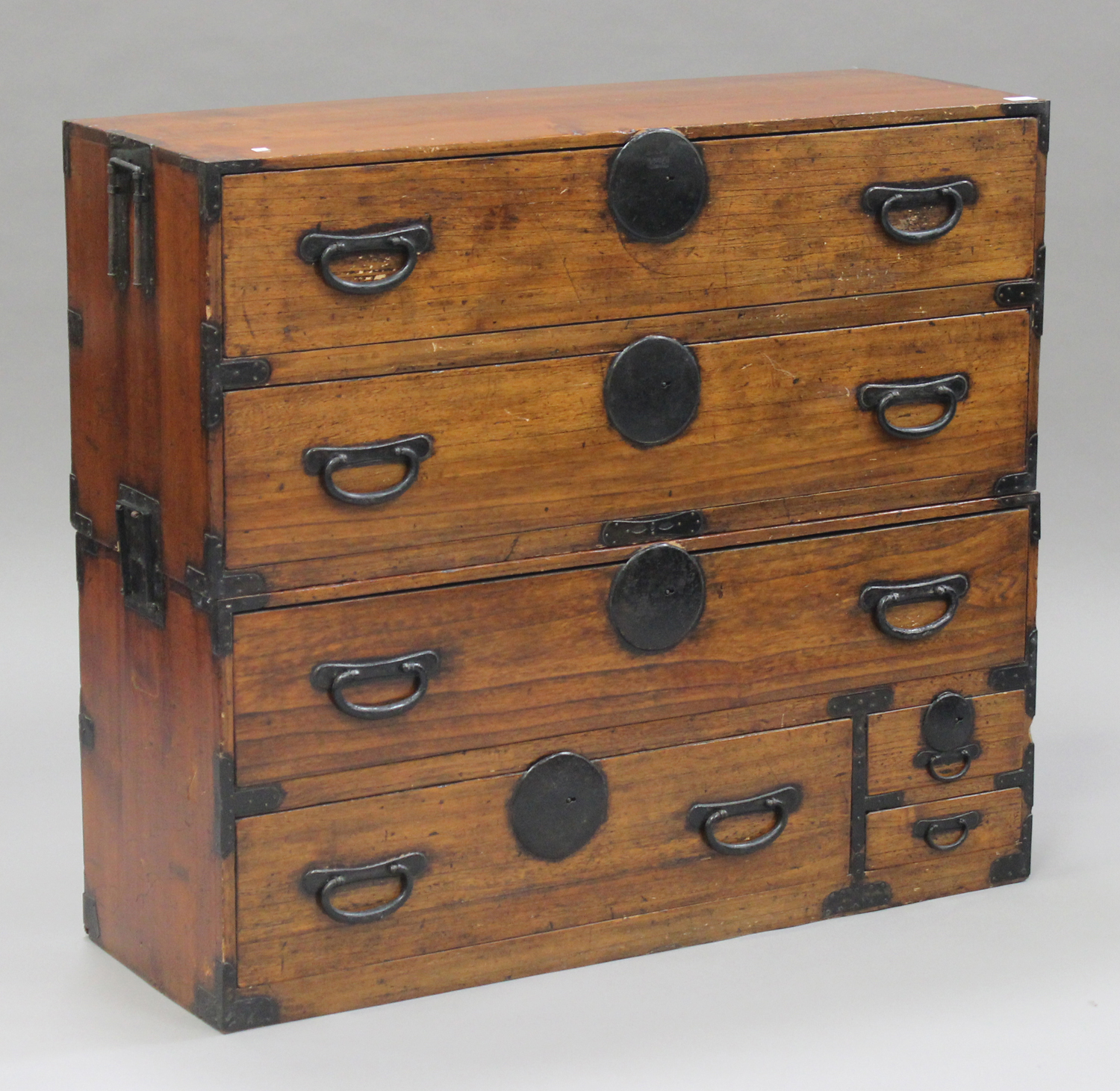 A 20th century Japanese softwood chest of drawers with iron mounts, fitted with an arrangement of