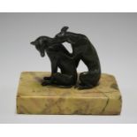 A 19th century green patinated cast bronze model of two seated dogs, mounted on a Sienna marble
