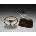 A French chromium plated racing trophy, pierced and cut in the form of an early racing car,