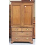 A late Victorian mahogany linen press, the moulded pediment above a pair of panel doors, the base