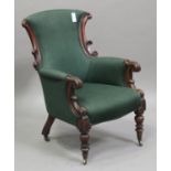 A Victorian mahogany showframe armchair, upholstered in green fabric, raised on turned baluster legs
