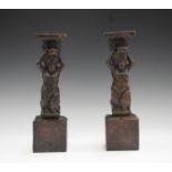 A pair of 17th century carved softwood figural supports, each modelled as a standing putto, height