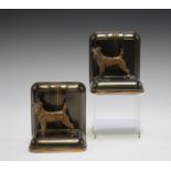 A pair of mid-20th century Art Deco anodized and copper bookends, each with a fox terrier