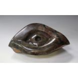 Victor Mtongwizo - an African carved stone model of a stylized eye, bearing incised signature,