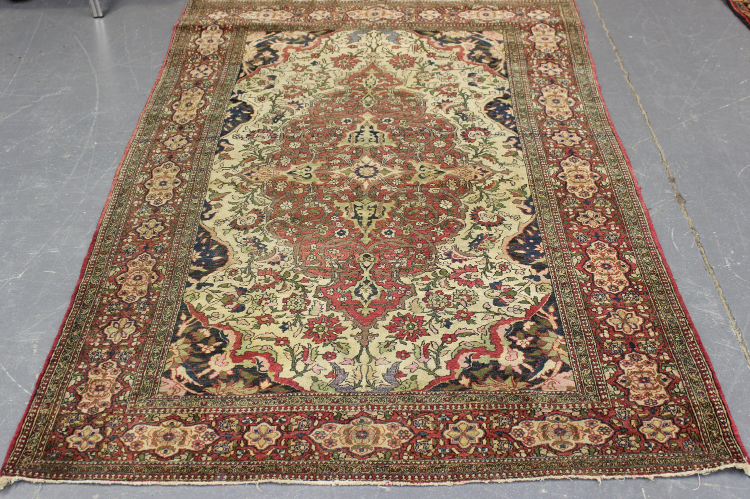 An Esfahan rug, Central Persia, early 20th century, the ivory field with a shaped foliate