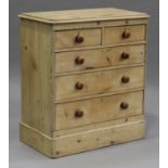 A late Victorian pine chest of two short and three long drawers with turned fruitwood handles, on
