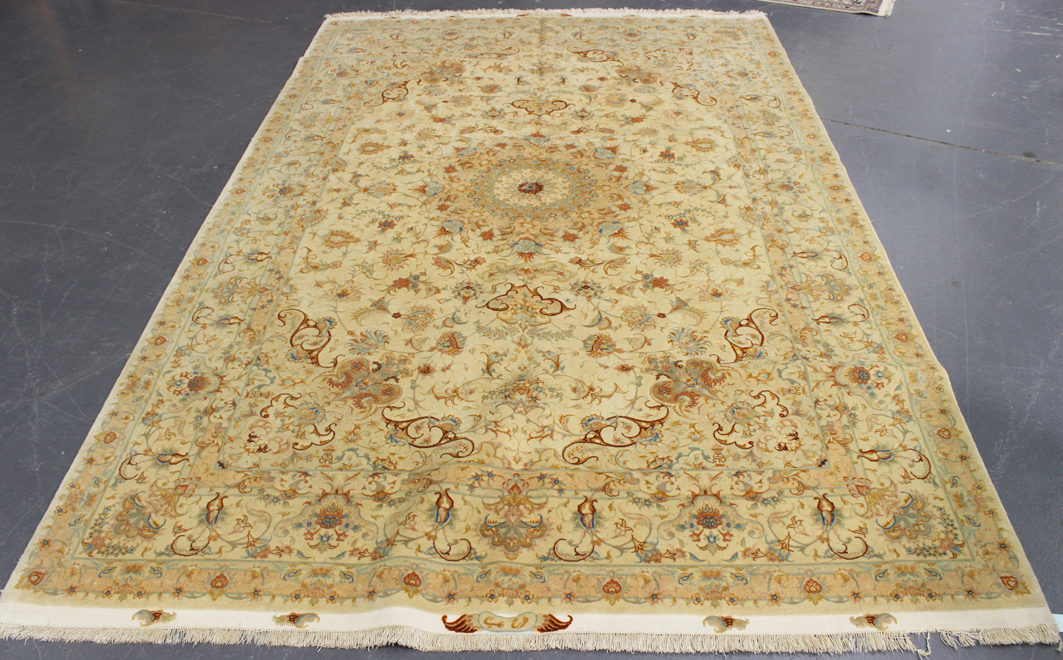 A fine Tabriz carpet, Central Persia, modern, the cream field with a flowerhead medallion, supported