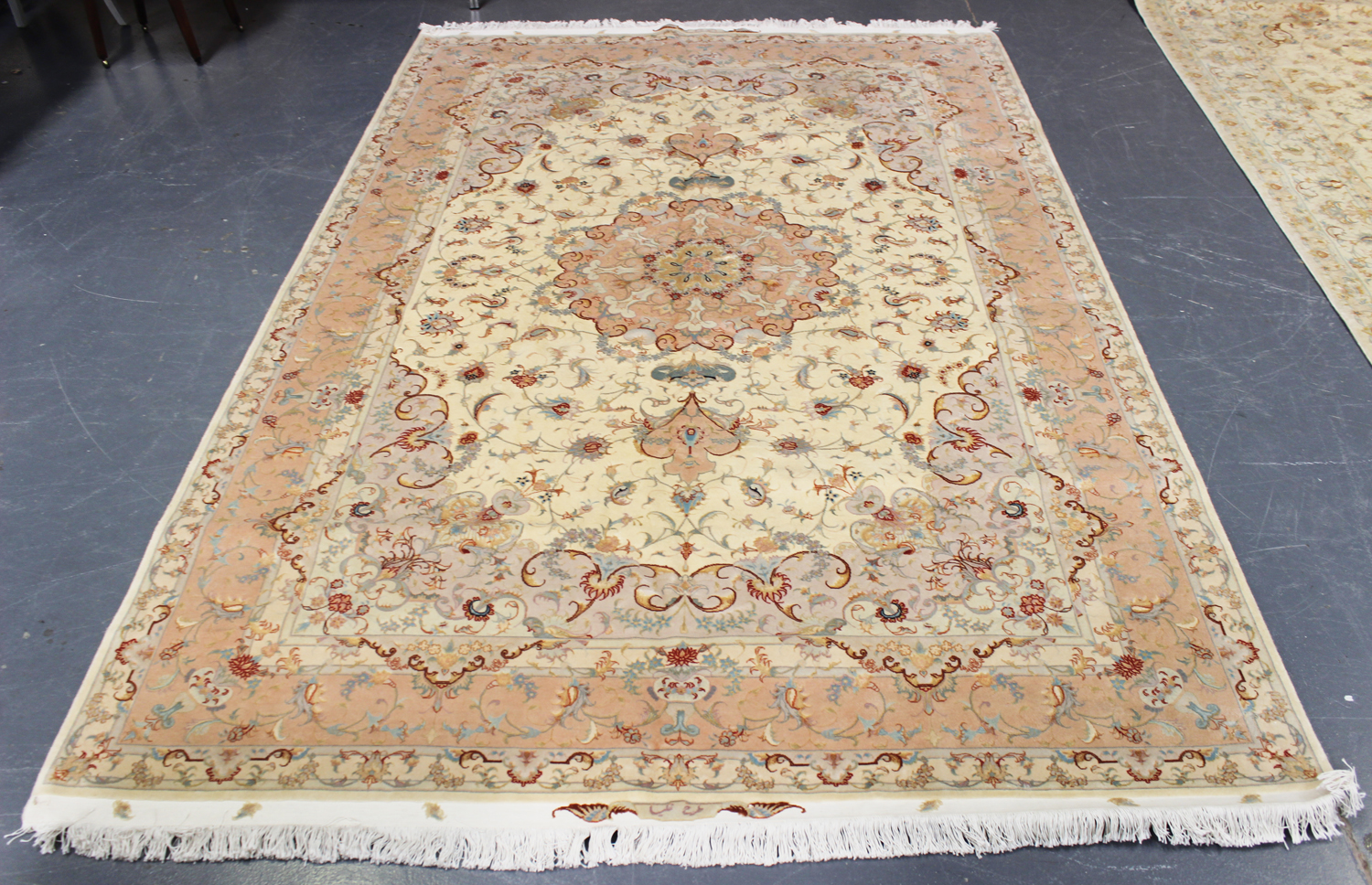 A fine Tabriz carpet, Central Persia, modern, the ivory field with a scrolling flowerhead medallion,