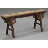 A 19th century Chinese elm and softwood bench with carved supports, on turned legs, height 51cm,