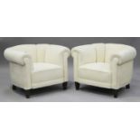 A pair of mid-20th century Danish tub back armchairs, upholstered in cream fabric, on square