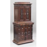 A late 19th century Continental walnut side cabinet, fitted with four carved and panelled doors, the